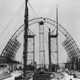 The first wooden arch is completed. Assembled arch sections awaiting placement can be seen on either side of the box car. (Brunswick Golden Isles Airport)